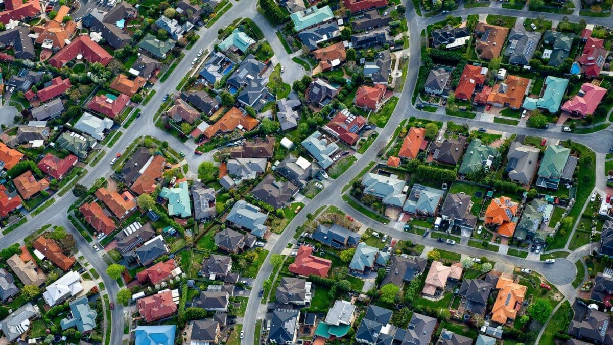 Aerial view of a residential suburb showing houses, streets, gardens and neighbourhood layout.
